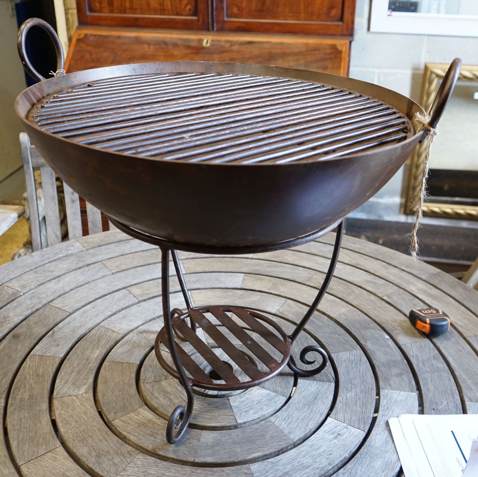 A wrought iron fire pit, diameter 61cm height 57cm